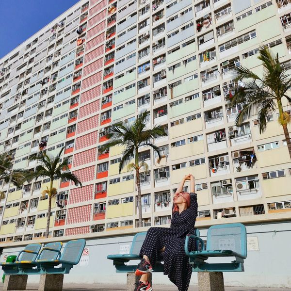 Person feeling energized and stretching outdoors with the sun rising.